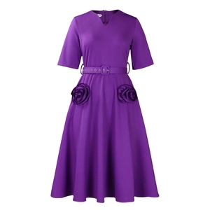 Detail of elegant V-neck purple dress with 3D floral accents and eyelet waist belt
