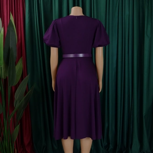 Detail view of deep purple midi dress with puff sleeves and invisible back zipper closure