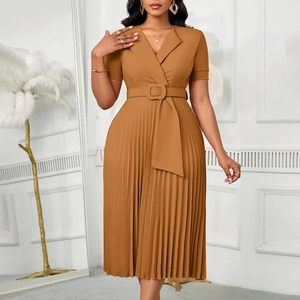 Detail of caramel pleated dress featuring a belted waist and sharp accordion pleats