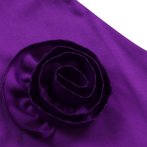 Close-up of elegant purple V-neck dress featuring a large handmade 3D rose flower detail