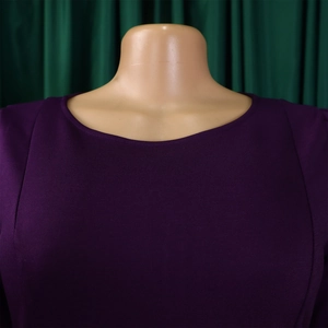 Close-up of the elegant purple dress neckline showing fine twill texture and stitching