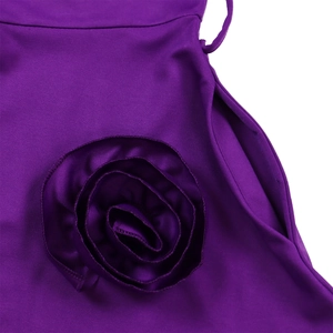 Detailed macro view of a 3D purple fabric rosette and functional side pocket on the dress