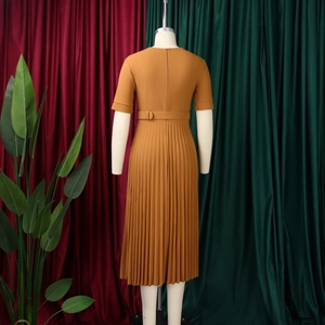 Detail of ginger yellow short sleeve dress featuring high waist and pleated skirt back view