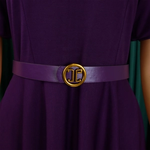 Detailed view of deep purple A-line dress with elegant gold buckle belt and puff sleeve texture