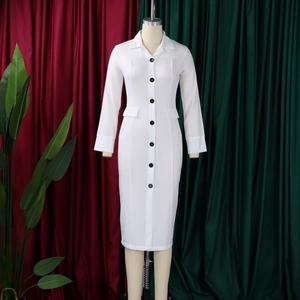 Close-up of white pencil dress featuring black buttons and lapel collar on a mannequin