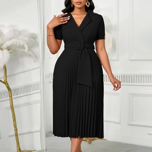 Detail of elegant V-neck pleated dress featuring a buckled waist belt and sleek black fabric