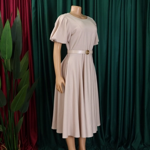 Side view of beige puff sleeve midi dress featuring elegant waist belt on mannequin