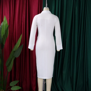 Detail view of the back seams and slim fit design of the white pencil midi dress