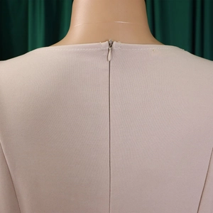 Detail of invisible back zipper on a puff sleeve A-line dress with knit texture