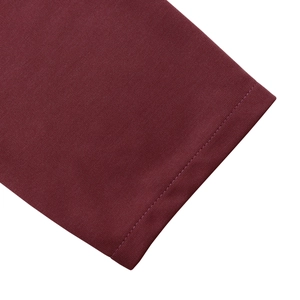 Detailed close-up showing the double-needle stitching on burgundy knitted dress sleeves
