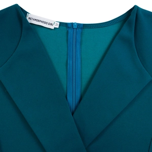 Detail view of the V-neckline and back invisible zipper on the dark teal dress