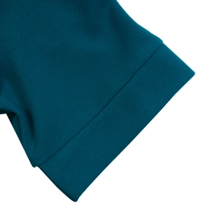 Detail of double-needle stitching on the short sleeves of a dark teal V-neck dress