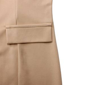 Detailed close-up of a premium khaki suit blazer pocket with precision stitching