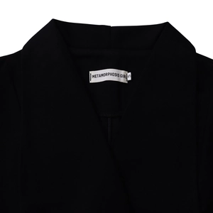 Detail of elegant black dress neckline with white METAMORPHOSIS GIRL brand label size S