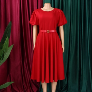 Detail of red crew neck dress featuring puff sleeves and a waist belt with golden buckle