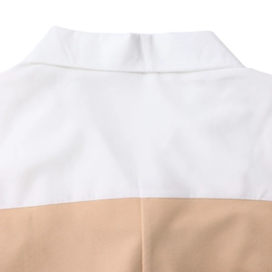 Detailed view of two-tone lapel collar with high-quality stitching and fabric texture