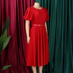 Detail of red crew neck dress with puff sleeves and waist belt with golden buckle