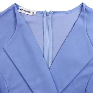Detail view of the V-neckline and back concealed zipper on the blue dress fabric