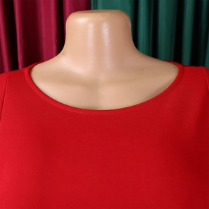Detail of red round neckline on puff sleeve dress with high-quality knit texture