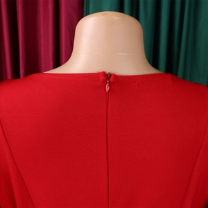 Detail of red dress showing textured fabric and hidden back zipper on a mannequin