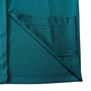 Detailed close-up showing precision stitching on the side slit of a knit pencil dress