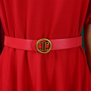 Detail of red dress with matching leather belt and vintage gold logo buckle