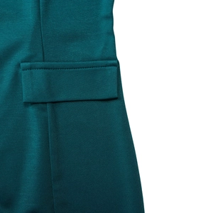 Close-up of flap pocket detail on teal business pencil dress with textured fabric