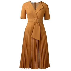 Detail of V-neck mustard yellow pleated dress featuring a matching square buckle belt