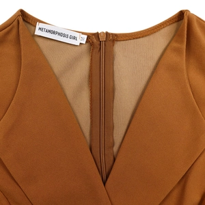 Detail of caramel V-neck dress featuring a hidden back zipper and premium textured fabric