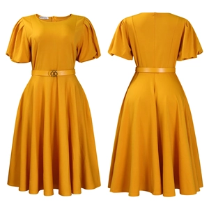 Detail of elegant mustard yellow A-line dress featuring puff sleeves and belted waist