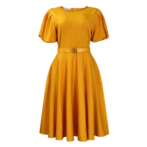 Detail of elegant yellow puff sleeve dress featuring a gold buckle belt and A-line waist
