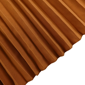 Detailed close-up of pleated caramel brown fabric showing fine accordion fold texture