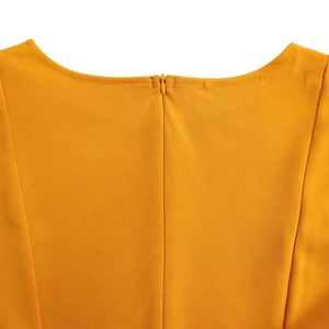 Detail of hidden zipper and high-quality stitching on ginger yellow dress back neckline