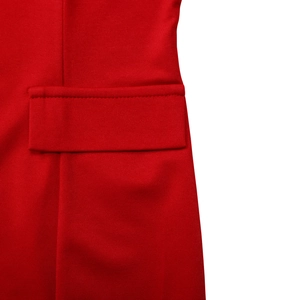 Detailed view of red pencil dress flap pocket with premium stitching and woven texture