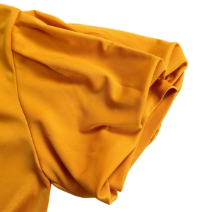 Detail of elegant mustard yellow puff sleeve with pleated texture on an A-line dress