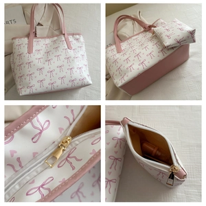 Detail view of pink bow print tote bag showing gold zipper hardware and interior pouch
