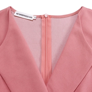 Detail of pink V-neck dress featuring a discrete back zipper and brand size label