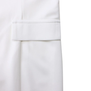 Detailed macro view of high-quality white dress fabric featuring a neat flap pocket seam