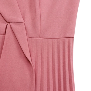 Detail of pink V-neck dress featuring delicate pleated fabric and elegant wrap design