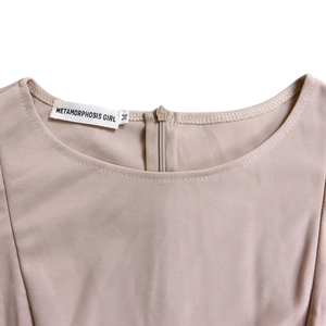 Detail shot of apricot A-line dress featuring a round neck and invisible back zipper