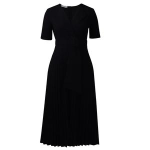 Close-up of elegant black V-neck dress featuring refined pleated skirt and waist belt