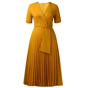 Detailed view of the pleated hem and waist belt on this yellow V-neck dress