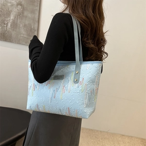 Large blue faux leather tote bag with letter embossing and colorful wave embroidery