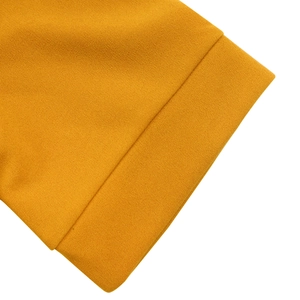 Close-up of mustard yellow dress featuring fine textured fabric and clean stitching
