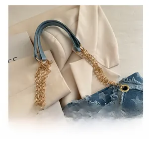 Detail of comfortable denim tote shoulder strap with gold chain and star pattern