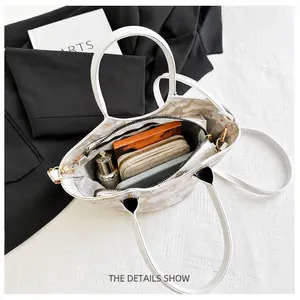 Top view of white leather tote bag interior with floral lining and spacious compartments