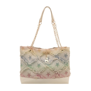 Denim tote bag with star patterns, frayed edges, and gold chain straps in gradient finish