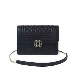 Women's black quilted crossbody bag with vintage gemstone buckle and metal chain strap