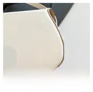 Close-up of white leather saddle bag showing rounded corners and precise stitching detail