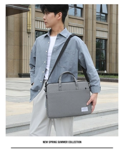 Close-up of grey waterproof canvas laptop briefcase with adjustable shoulder strap
